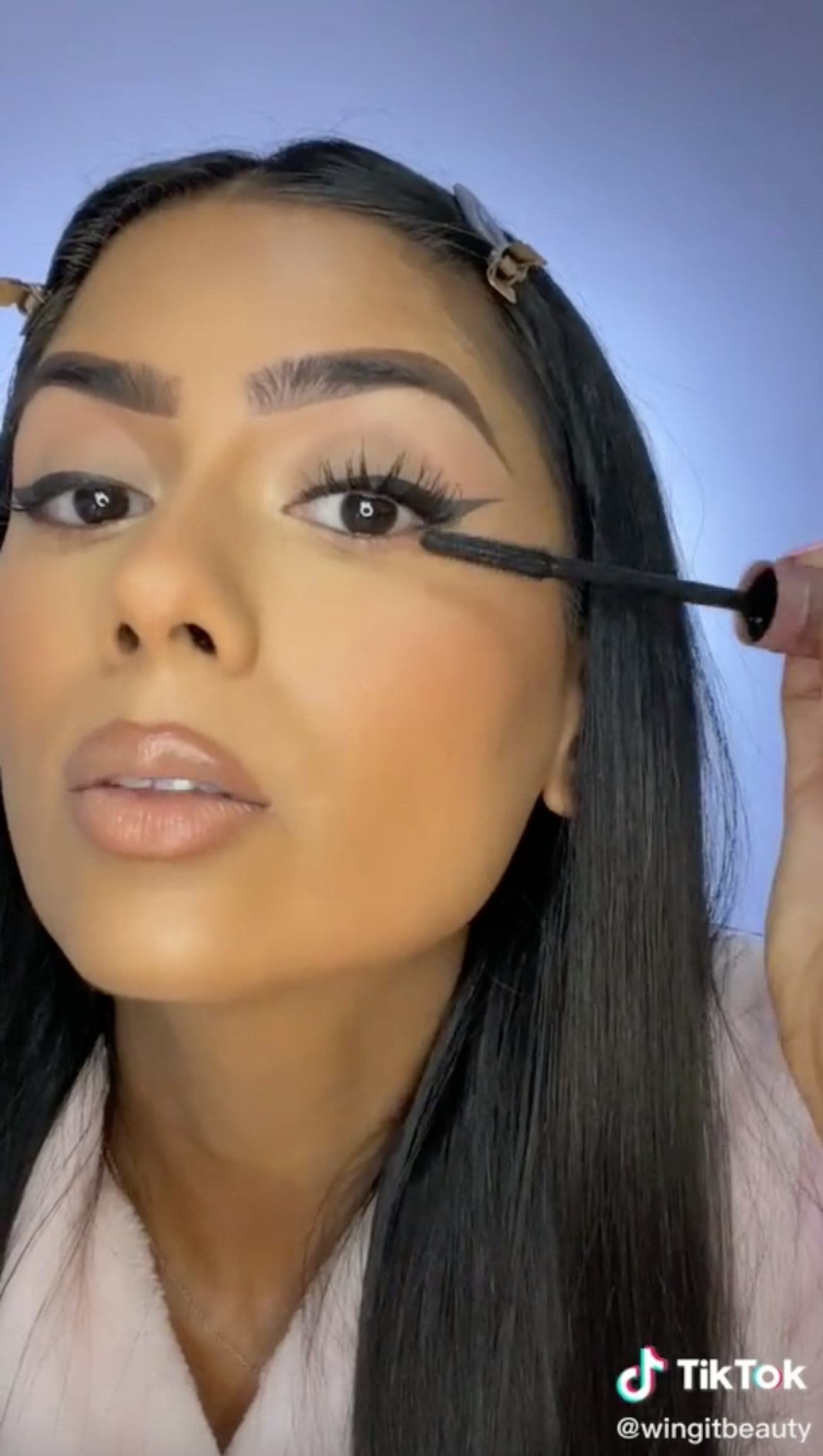 TikTok user runs wand of Maybelline Mascara through her eyelashes 