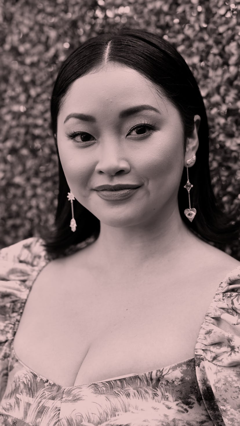 Lana Candor, in a dress with fluffy, floral sleeves, smiles