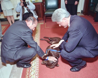 President Clinton and President Chirac of France petting the dog Buddy in 1999. 