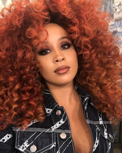 Jillian Hervey with a curly red hair posing for a photo