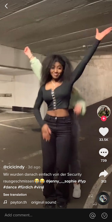 Two TikTok users do the "Domino" dance challenge while standing in a parking garage.