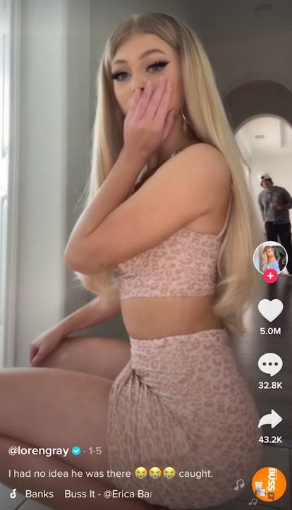 Lore Gray looks surprised to see someone behind her while doing the "Buss It" challenge on TikTok. 