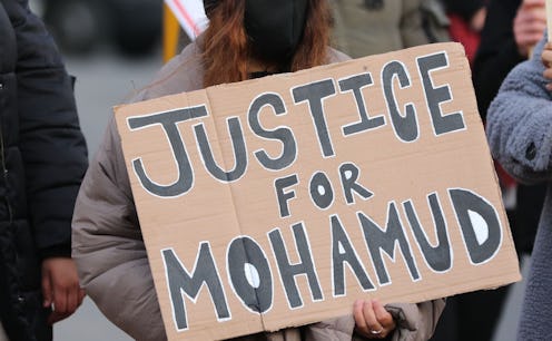 A woman holds a sign at the protest about Mohamud Mohammed Hassan's death in Cardiff, Wales.