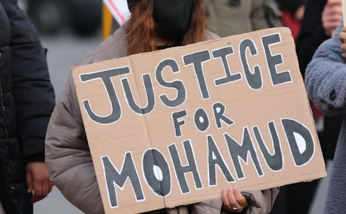 A woman holds a sign at the protest about Mohamud Mohammed Hassan's death in Cardiff, Wales.