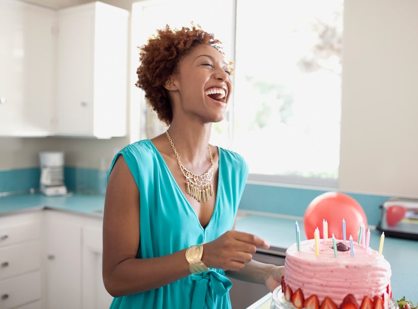 Young woman celebrating birthday with cake