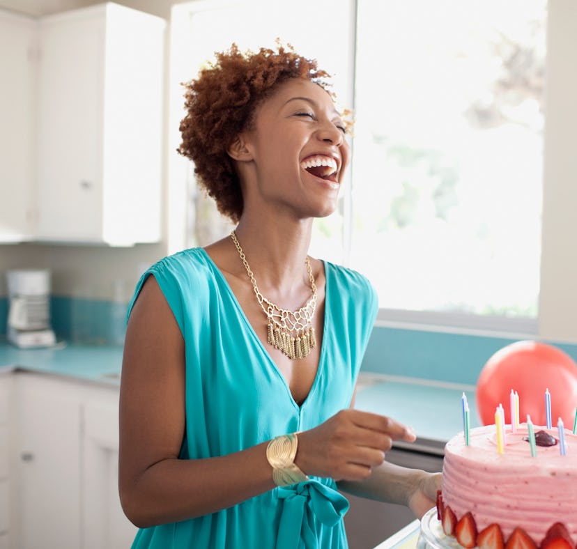 Young woman celebrating birthday with cake