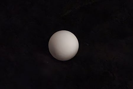 Trying to trick the S21 Ultra camera to overlay alleged moon textures onto a ping pong ball on a black background.