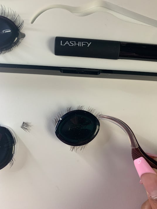 Lifting a Lashify lash extension with application tool. 
