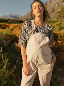 Model wearing patterned blouse and white maternity overalls from the Hatch Maternity Collection At T...