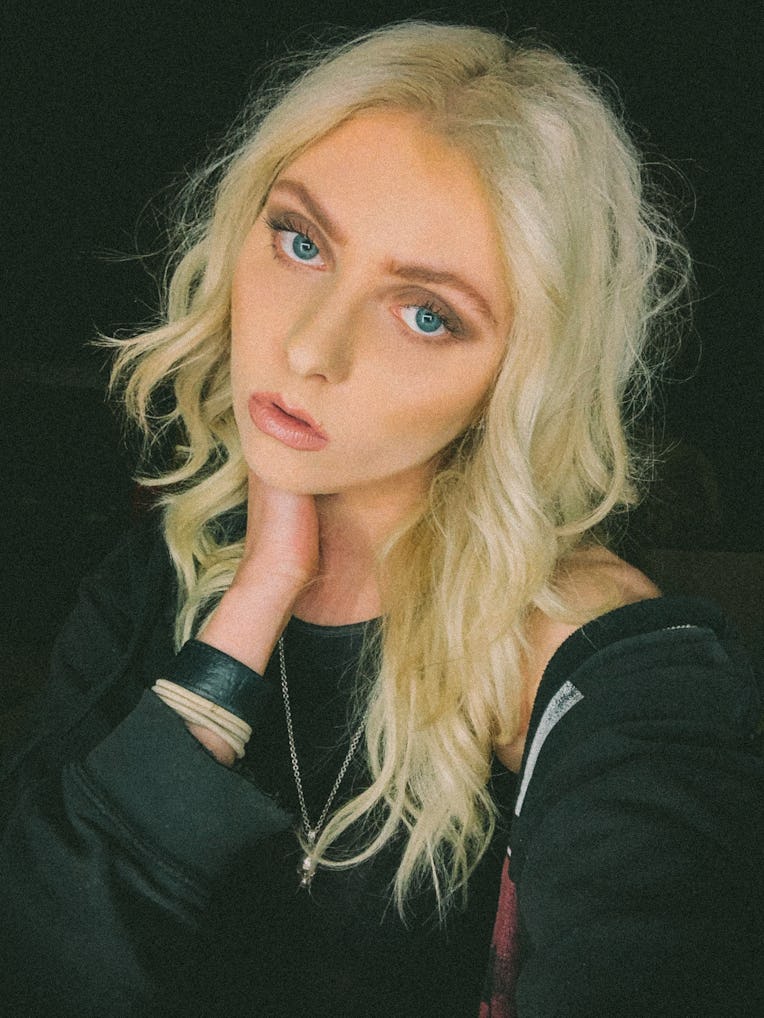 Taylor Momsen taking a selfie in a black shirt in, a black tank top and a black hoodie with a black ...