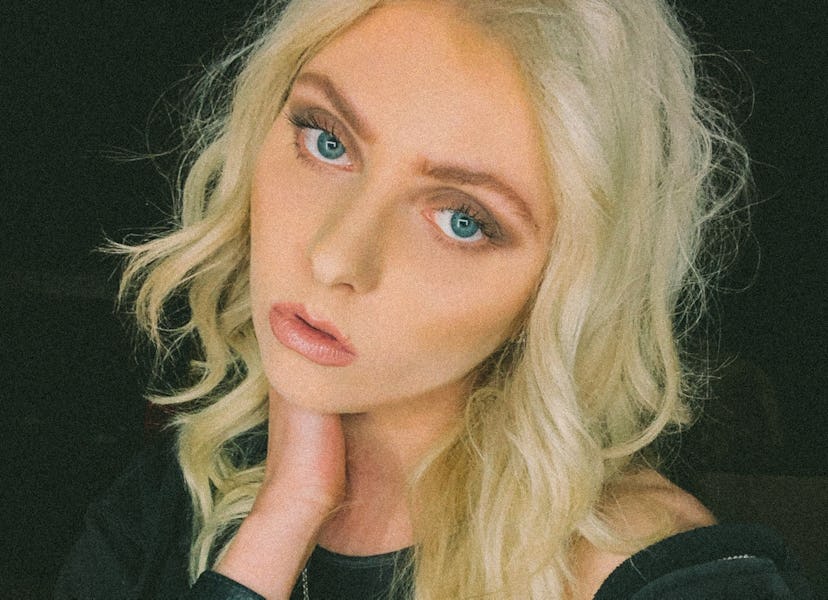 Taylor Momsen taking a selfie in a black shirt in, a black tank top and a black hoodie with a black ...