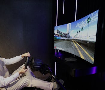 A gamer sits in front of a curved LG display.