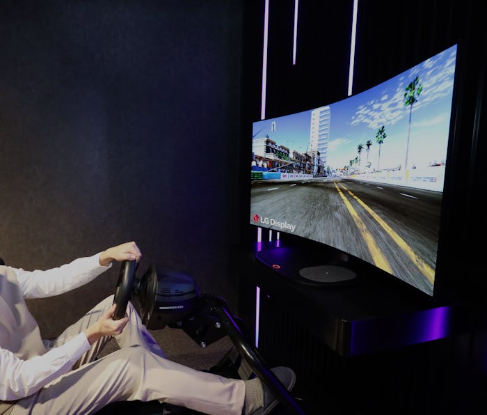 A gamer sits in front of a curved LG display. 