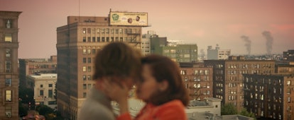 A young couple kiss on a rooftop in the city at sunset during Justin Bieber's "Anyone" music video.