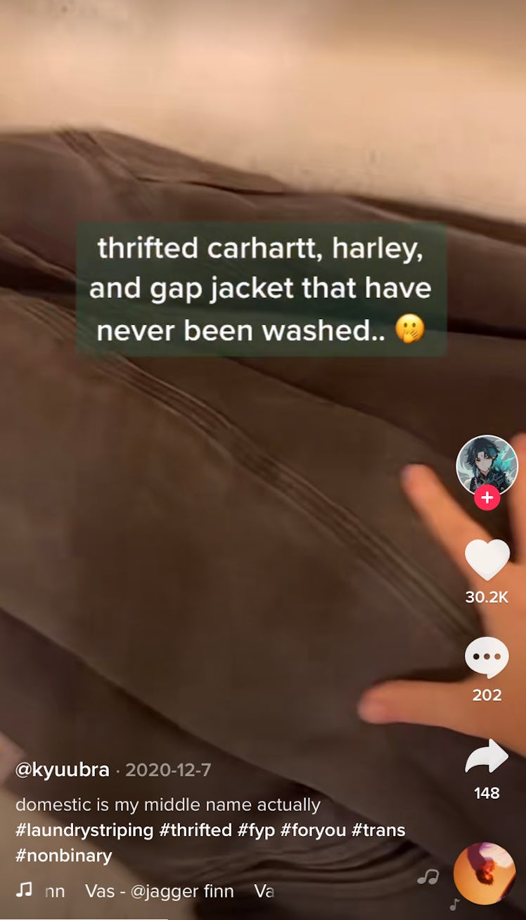 A woman throws a thrifted jacket into a bathtub to laundry strip on TikTok. 