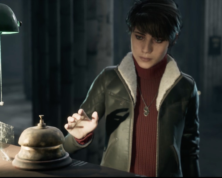 A screenshot of a woman ringing a bell in 'The Medium.'
