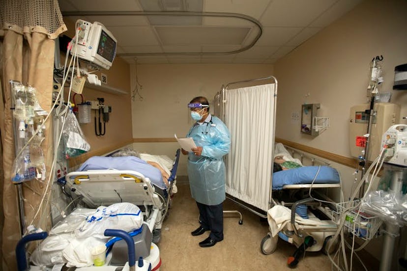 A doctor checks on patients in a temporary space at an overloaded hospital near Los Angeles.