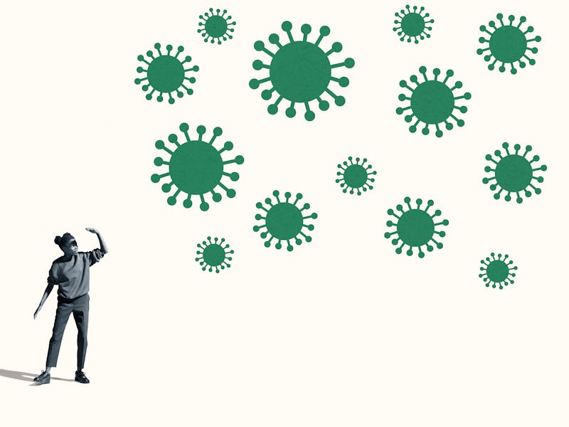 A young woman shielding herself from large green coronavirus.