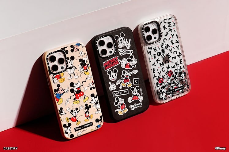 Three phone cases from the Disney x CASETiFY collection lean up against a wall, and sport old design...