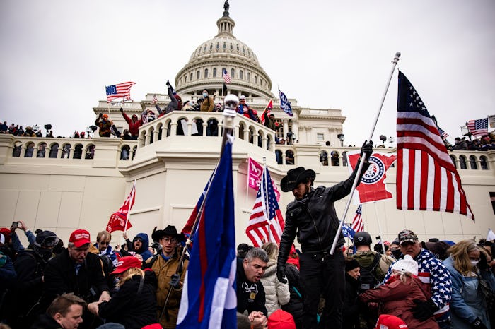 Trump supporters clash with police and security forces, climbing scaffolding as they try to storm th...