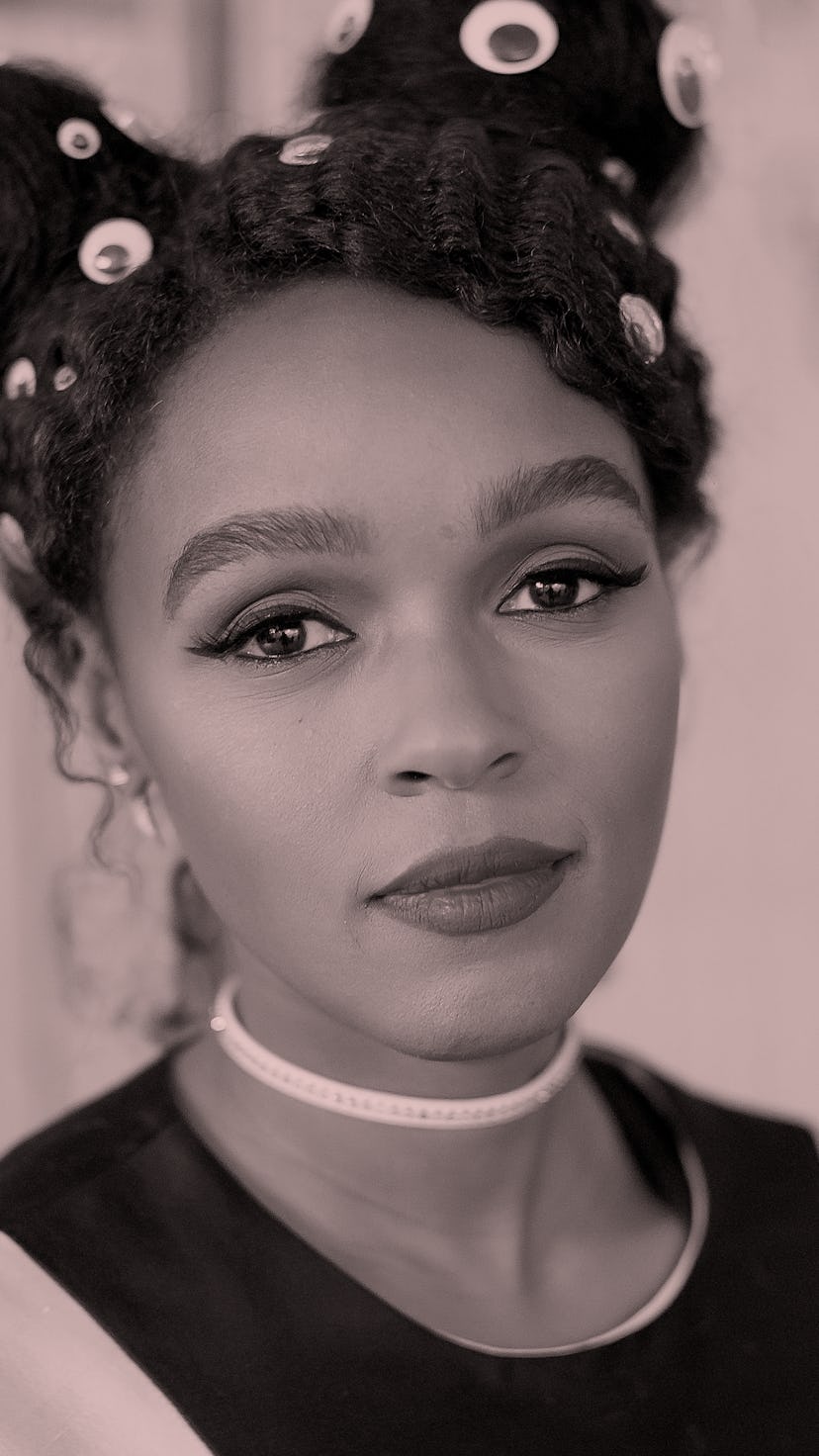 Janelle Monae, wearing her hair in two braided space buns that featured eye stickers, smiles at the ...