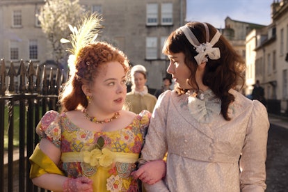 Eloise and Penelope from 'Bridgerton' look at each other while they chat and cross arms for a sunny ...