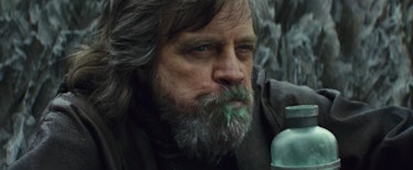 Mark Hamil as Luke Skywalker holding a water bottle in the scene from The Last Jedi movie