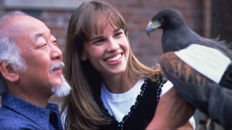 Will Hilary Swank looking at a black bird while smiling 