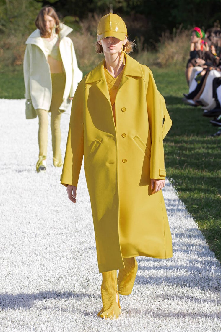 A model in a yellow Courreges look walking 
