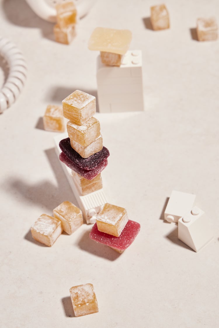 gummies in various colors and sizes artfully arranged with white Legos