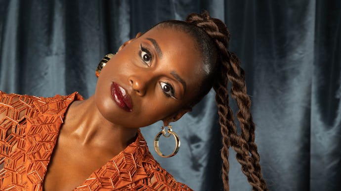 Issa Rae in an orange dress posing for The Good Ones Issue: The Voices that Made an Impact
