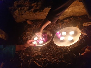 White and pink candles spread out on two platters shaped like shells