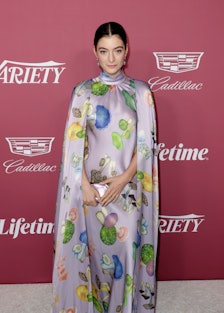 Lorde wearing a mushroom-covered cape gown by Rodarte