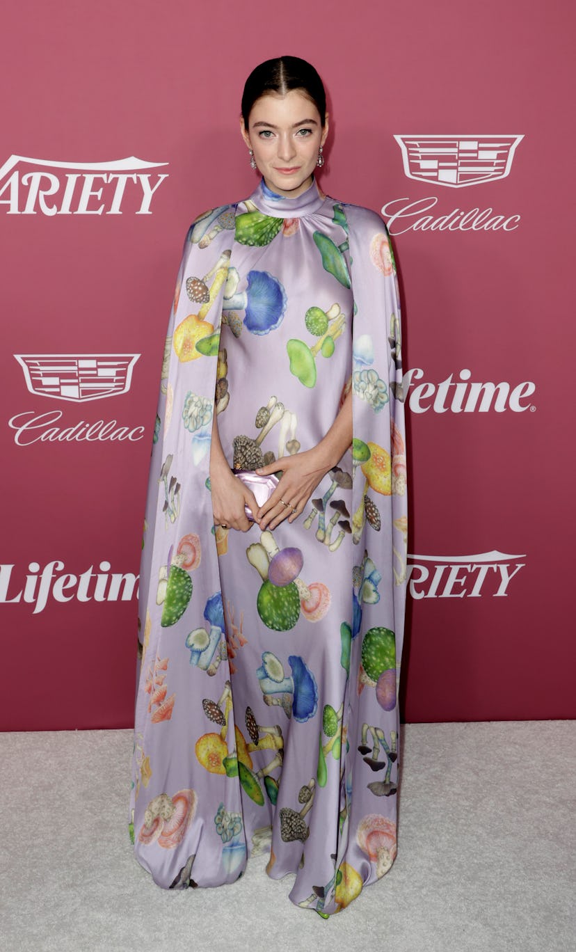 Lorde wearing a mushroom-covered cape gown by Rodarte