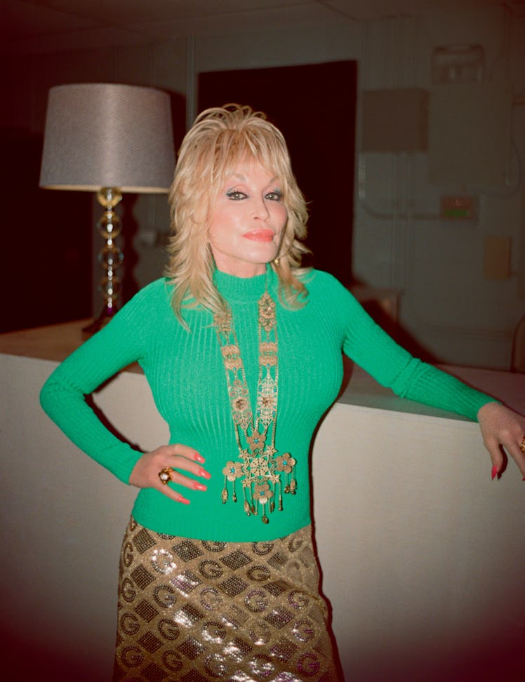 Dolly Parton wears a Gucci turtleneck, skirt, necklace, and rings; her own earrings.