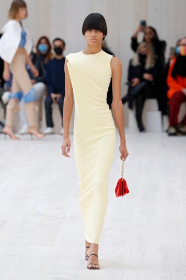 A model walking in a beige dress at the Loewe spring 2022 show at Paris Fashion Week.