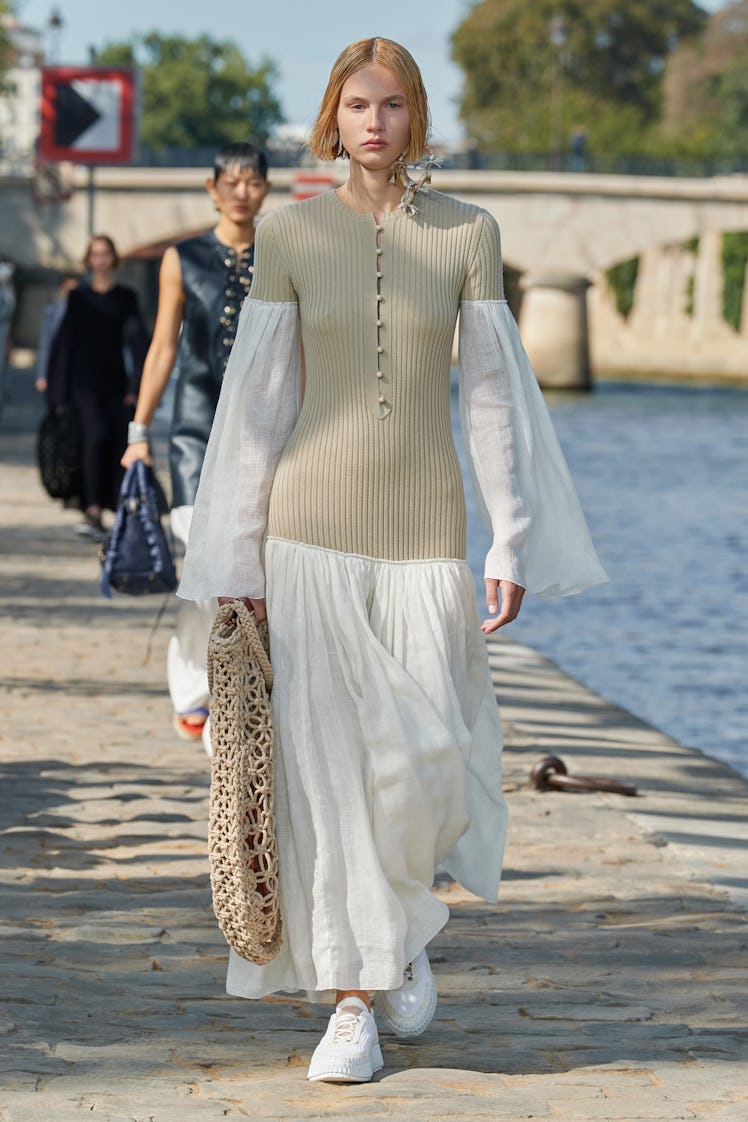 Model walking in a beige-white dress at the Chloé fashion show at Paris Fashion Week Spring 2022