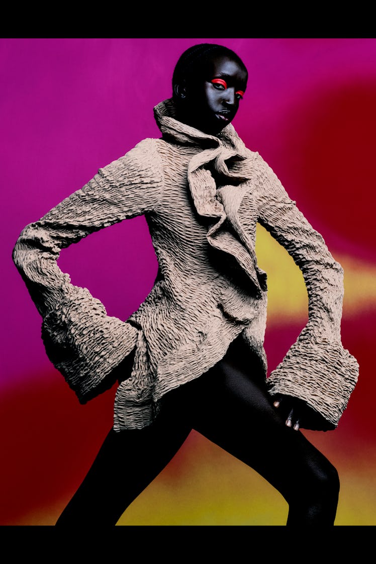 A model in  a beige jacket and black pants by Dries Van Noten