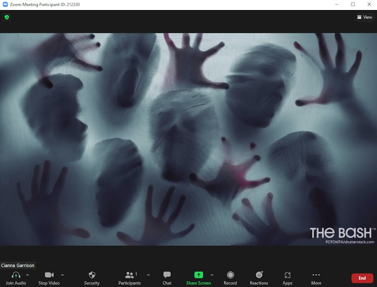 This scary Halloween Zoom background includes ghostly figures through a window.