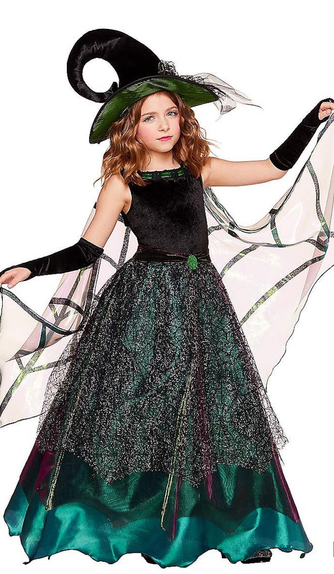 Little girl posing in green gown/witch costume