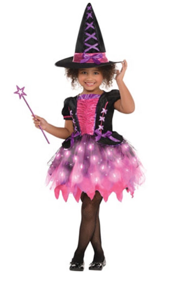 Girl posing in pink witch costume