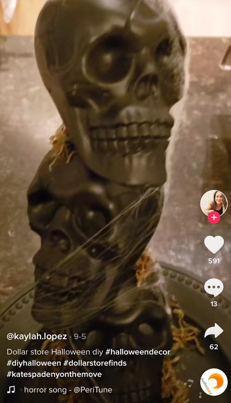 A woman shows off her best dollar store decor hacks for Halloween on TikTok with these stacked skull...