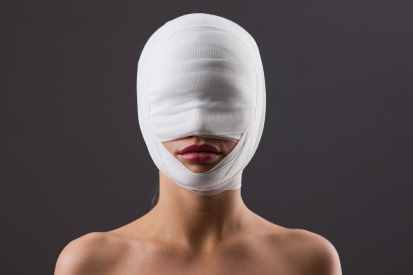 Woman with face wrapped in gauze 