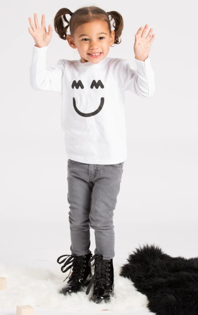 Little girl wearing long sleeve tee shirt with smile face on it