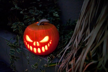 Scary face Jack-O-Lantern lit up at night