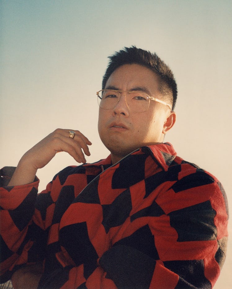 Bowen Yang in red and black jacket.