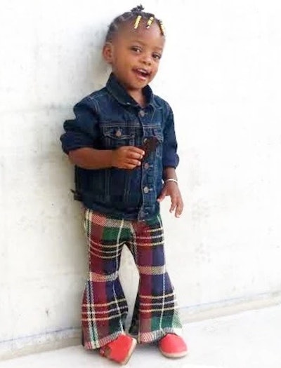 Little kid modeling plaid flare pants 