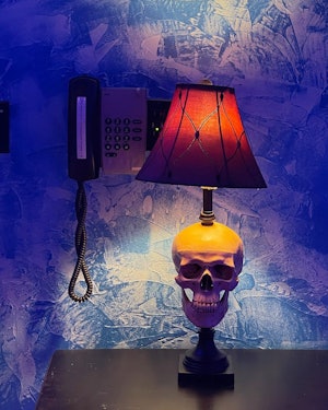 A skull-shaped lamp in a hotel room
