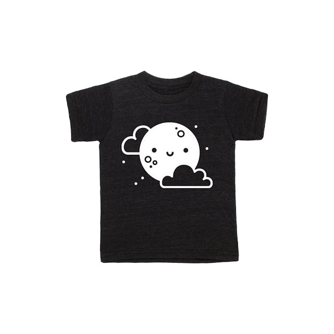 Flat lay of black tee shirt with smiling moon graphic 
