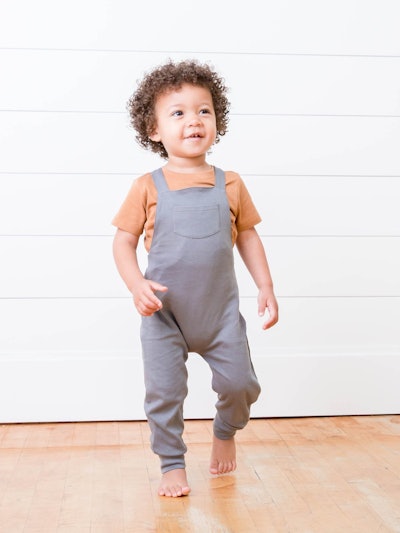 Toddler modeling grey overalls